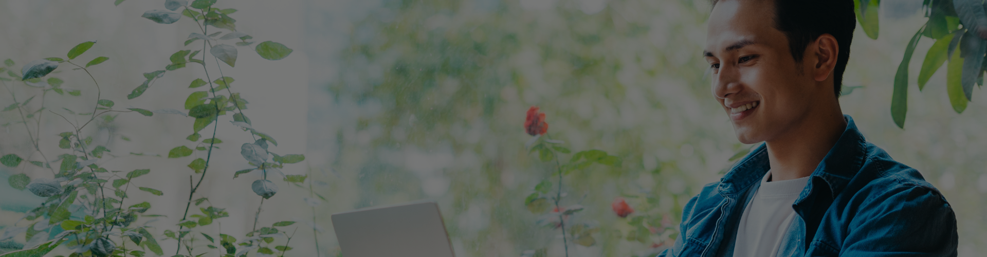 Man working on his laptop outside banner
